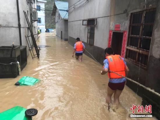 圖為浙江省麗水市遂昌縣民警在積水中準(zhǔn)備營救居民。