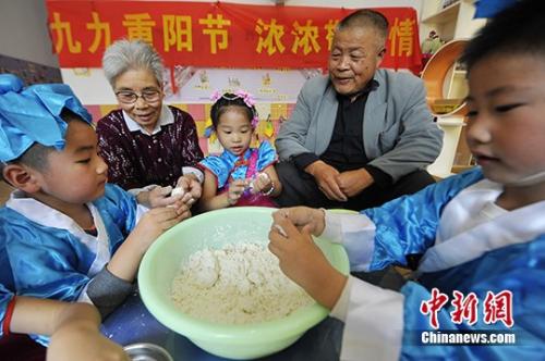 資料圖：小朋友與老人共做重陽(yáng)糕。 孟德龍 攝